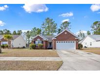 Charming single-story brick home featuring a two-car garage and well-manicured lawn at 3124 Ivy Lea Dr., Conway, SC 29526