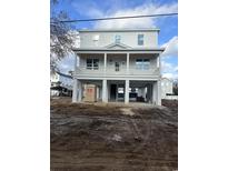 New construction coastal home featuring elevated design with gray siding, porch and white pillars at 318 Vista Dr., Murrells Inlet, SC 29576