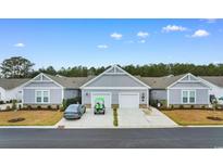 Charming townhomes featuring light gray siding, white trim, two-car garages, and well-manicured lawns at 4027 Taranto Loop # 3203-C, Myrtle Beach, SC 29579