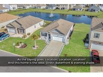 Charming single-story home boasts a well-manicured lawn and a serene water view with a fountain feature at 417 Accord St., Myrtle Beach, SC 29588