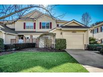 Charming townhouse with a one-car garage, red shutters, and a well-maintained lawn in a desirable neighborhood at 4498 Girvan Dr. # D, Myrtle Beach, SC 29579