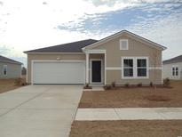 Charming single-story home with a two-car garage and manicured front yard at 456 Ribbon Rail Way, Loris, SC 29569