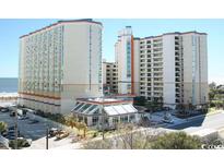 An exterior view of a high-rise condo building by the beach, with beach views at 5200 N Ocean Blvd. # 152, Myrtle Beach, SC 29577