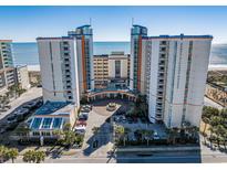 Beautiful beachfront resort with multiple towers, palm trees, and a circular driveway at 5200 N Ocean Blvd. # 155, Myrtle Beach, SC 29577