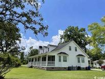 Charming two-story home with a covered porch and well-maintained lawn at 721 Old Buck Creek Rd., Longs, SC 29568