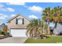 Charming brick home with a well-maintained lawn and mature palm trees at 7228 Guinevere Circle, Myrtle Beach, SC 29588