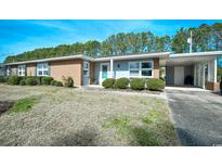 Charming single story brick and gray home with carport and manicured front yard at 821 Pampas Dr. # 821, Myrtle Beach, SC 29577