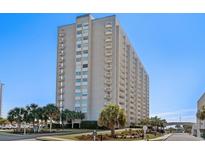 A beachfront condo building boasts numerous balconies and lush landscaping at 9820 Queensway Blvd. # 1502, Myrtle Beach, SC 29572