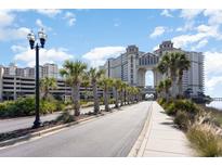 Scenic view of the resort exterior, featuring palm trees lining the road and architecture with skybridge at 100 North Beach Blvd. # 506, North Myrtle Beach, SC 29582