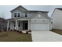Charming two-story home with a two car garage, covered porch, and tastefully landscaped front yard at 1010 Laconic Dr., Myrtle Beach, SC 29588