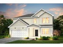 Two-story home featuring a two-car garage, black front door, lawn, and manicured garden beds at 1010 Laconic Dr., Myrtle Beach, SC 29588