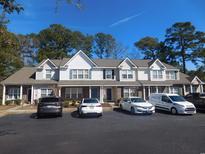Charming townhomes with neutral siding, well-manicured landscaping, and ample parking in a desirable community at 1027 Pinwheel Loop # 3103, Myrtle Beach, SC 29577