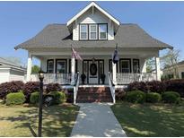 Charming two-story traditional home with a welcoming front porch and manicured landscaping at 103 South Rosemary Ave., Andrews, SC 29510