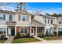 Two-story townhome featuring stone accents, red shutters, covered entry, and manicured landscaping at 1078 Dinger Dr. # 1078, Myrtle Beach, SC 29588