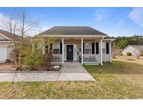 Charming single-story home features a cozy front porch with black shutters and a walkway leading to the entrance at 113 Cat Tail Bay Dr., Conway, SC 29527