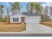 Charming single-story home with a well-manicured lawn, inviting entrance, and an attached two-car garage at 123 Marley Blue Dr., Little River, SC 29566