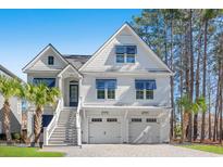 Stunning two-story home with white siding, blue accents, and a charming staircase leading to the front entrance at 125 Harbor Oaks Dr., Myrtle Beach, SC 29588