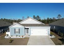 Charming one-story home featuring a two-car garage, light blue siding, and manicured landscaping at 127 Clover Walk Dr., Conway, SC 29526