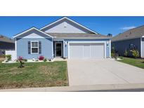 Charming blue single-story home with a well-manicured lawn, white gravel accents and a two-car garage at 127 Clover Walk Dr., Conway, SC 29526