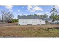 Two-car garage featuring dual doors and stone accents, offering ample space at 1715 Cane Branch Rd., Loris, SC 29569