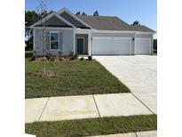 Charming single Gathering home featuring a two-car garage, well-manicured lawn, and a beautifully landscaped front yard at 183 Glengrove Lane, Murrells Inlet, SC 29576