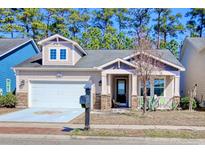 Charming single-Gathering home with stone accents, front porch, and two-car garage at 1878 Heritage Loop, Myrtle Beach, SC 29577