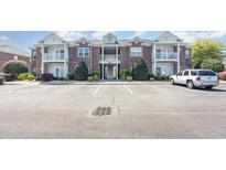 Inviting brick condo building features balconies, manicured landscaping, and convenient parking for easy access at 2033 Silvercrest Dr. # 21 B, Myrtle Beach, SC 29579