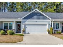 Charming home featuring a two-car garage, tidy landscaping and a quaint covered porch at 309 Lake Mist Ct. # 309, Longs, SC 29568