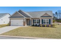 Charming single-story home featuring a two-car garage, neutral siding, and a well-maintained front yard at 351 Lakota Loop, Longs, SC 29568