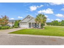 Charming single-story home with a well-manicured lawn, welcoming porch, and attached two-car garage at 3600 White Wing Circle, Myrtle Beach, SC 29579