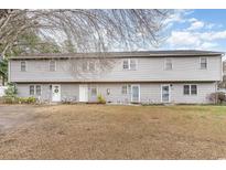 A charming two-story townhome with a well-maintained lawn at 4584 Lomax Ct. # 1B, Murrells Inlet, SC 29576