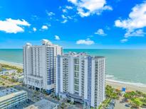 Stunning exterior view of a high-rise condo building with ocean views and meticulously landscaped grounds at 504 N Ocean Blvd. # 310, Myrtle Beach, SC 29577