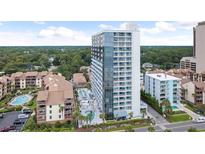 Stunning exterior view of condo building with pools, lush greenery, and beautiful landscaping at 5511 N Ocean Blvd. # 202, Myrtle Beach, SC 29577