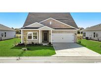 Charming single-story home featuring a brick facade, two-car garage, and well-manicured lawn at 555 Cypress Preserve Circle, Longs, SC 29568