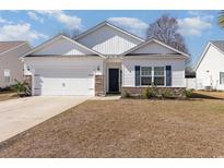 Charming single-story home with a two-car garage, brick accents, and manicured lawn in a quiet neighborhood at 577 Rycola Circle, Surfside Beach, SC 29575