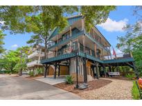 Stunning three-story stilt home with a basketball court and multiple decks for outdoor enjoyment at 6001- Mh44B S Kings Hwy., Myrtle Beach, SC 29575