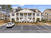 Inviting condo building with a charming staircase leading to upper units and well-maintained landscaping at 607 Sunnyside Dr. # 202, Murrells Inlet, SC 29576