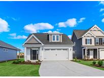 Charming single-Gathering home with a manicured lawn, a two-car garage, and stylish architectural detailing at 619 Castle Ct., Myrtle Beach, SC 29579