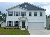 Charming two-story home with gray shutters, siding, and a two-car garage at 667 Mccorkle Place, Conway, SC 29526