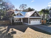 Charming single-Gathering home showcasing a metal roof, 2-car garage and well-maintained landscaping at 799 Mount Gilead Place Dr., Murrells Inlet, SC 29576