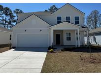 Charming two-story home featuring a two-car garage, covered entry, and landscaped front yard at 985 Laconic Dr., Myrtle Beach, SC 29588