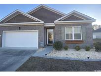 Charming brick home with a well-manicured front yard and attached garage at 112 Rialto Dr., Conway, SC 29526