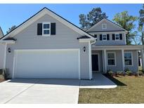 Charming two-story home featuring a two-car garage and a well-maintained lawn, perfect for families at 1275 Winding Creek Way, Myrtle Beach, SC 29588