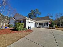 Charming single Gathering home with a well-manicured lawn, attached garage, and cozy front porch at 152 Rose Water Loop, Myrtle Beach, SC 29588