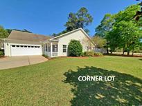 Well-maintained corner lot featuring an attached two-car garage and a cozy screened in porch at 152 Rose Water Loop, Myrtle Beach, SC 29588