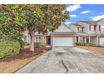 Charming two-story home featuring a brick facade, attached two-car garage, and well-manicured landscaping at 1547 Harlow Ct., Myrtle Beach, SC 29579