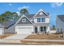 New two-story home showcasing a two-car garage and modern gray and white color scheme at 2473 Campton Loop, Conway, SC 29527