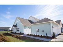 Charming coastal home with light blue siding, white trim, and well-maintained landscaping at 2476 Blue Crane Circle # 101, Myrtle Beach, SC 29577