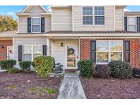 Inviting front entrance of a two story home with a brick accent wall and well maintained landscaping at 3557 Chestnut Dr. # 3557, Myrtle Beach, SC 29588