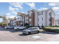 View of the apartment building showcasing its architecture and parking area on a sunny day at 3762 Citation Way # 1013, Myrtle Beach, SC 29577